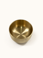 Brass singing bowl from above, showing the brushed interior and rounded base