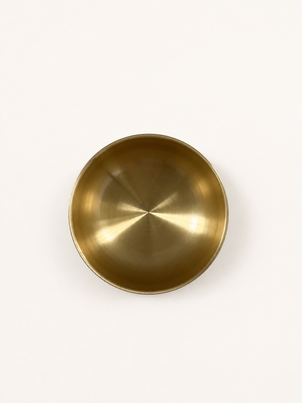 Brass singing bowl from directly overhead, interior filling the frame