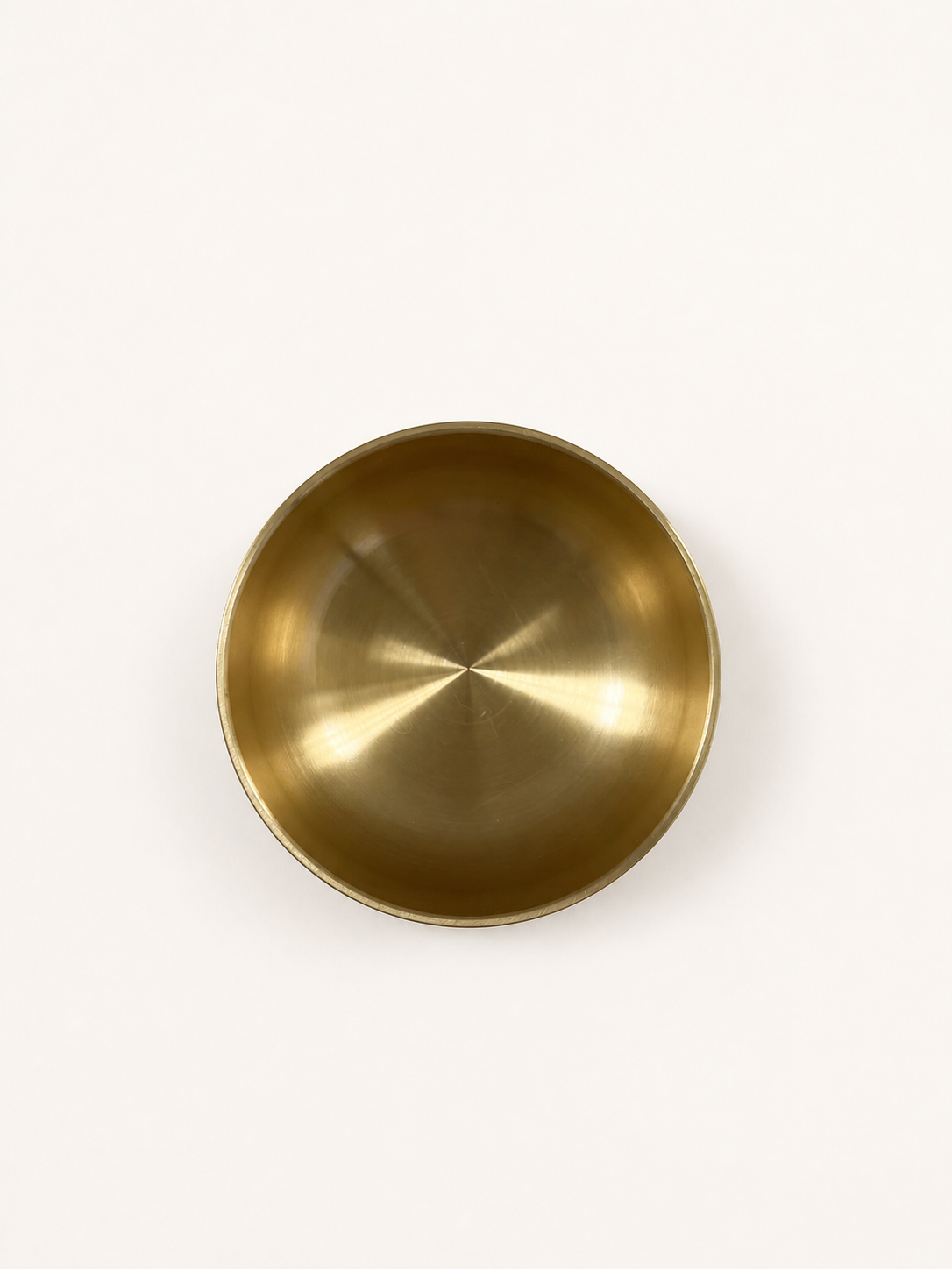 Brass singing bowl from directly overhead, interior filling the frame
