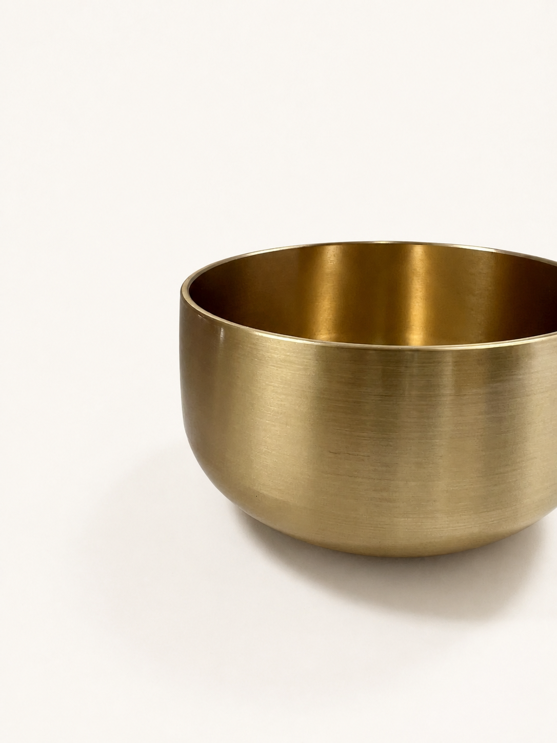Close view of the singing bowl's brushed outer wall and rounded base
