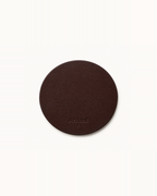 Aritual singing bowl pad in deep brown leather, debossed with the Aritual mark