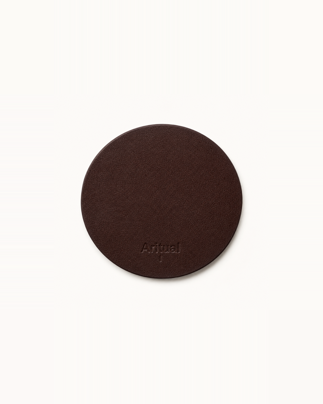 Aritual singing bowl pad in deep brown leather, debossed with the Aritual mark