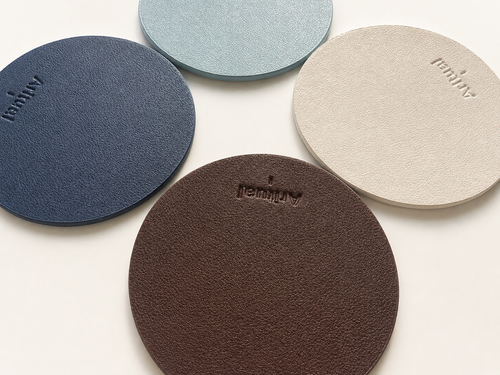 All four pad colorways close-up — navy blue, powder blue, ivory and deep brown leather