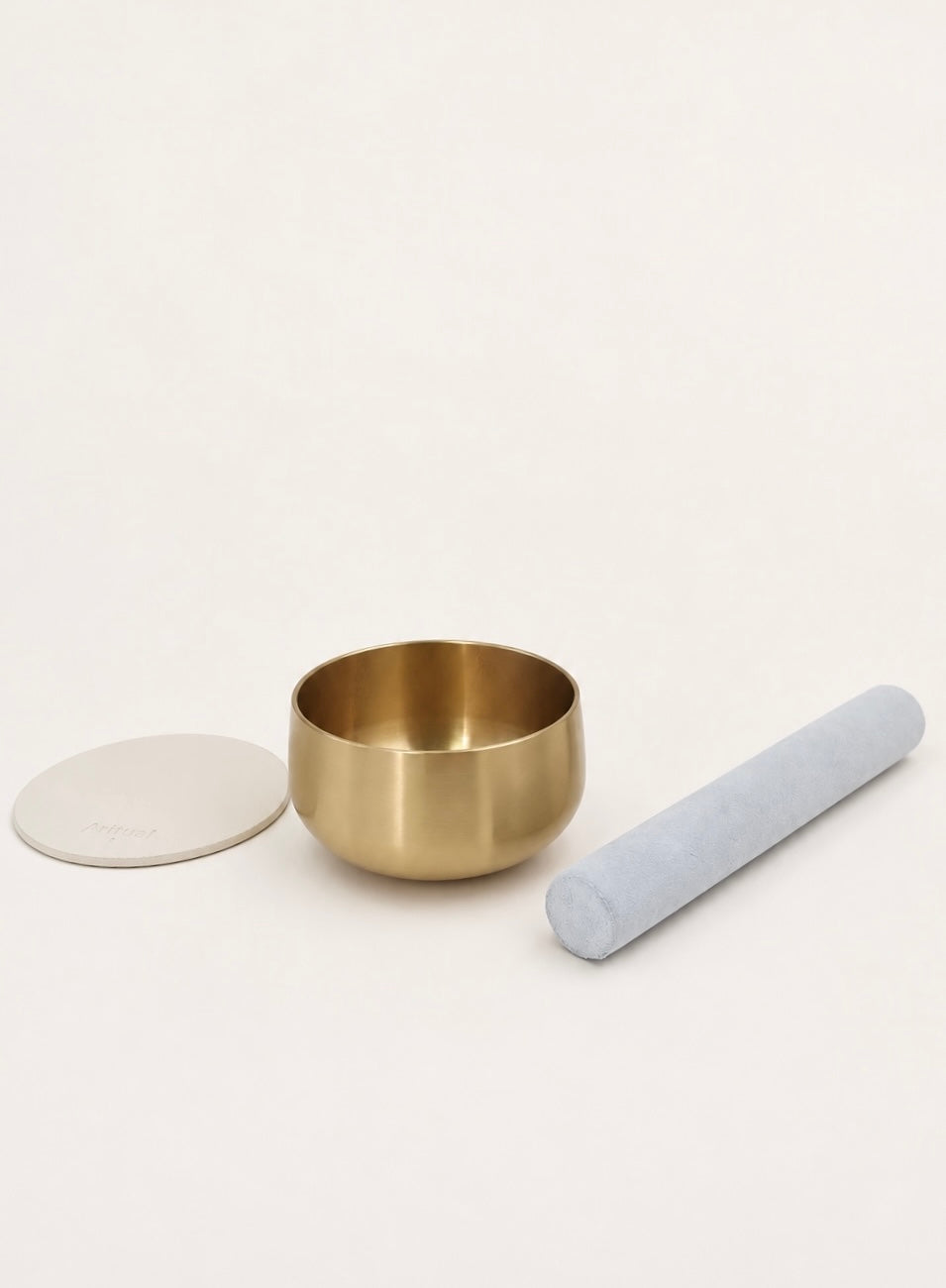 Singing Bowl Set laid out — brass bowl, suede mallet and ivory leather pad