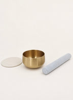 Singing Bowl Set laid out — brass bowl, suede mallet and ivory leather pad