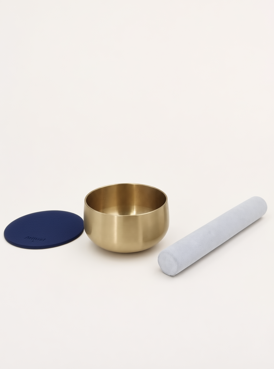 Singing Bowl Set laid out — brass bowl, suede mallet and navy blue leather pad