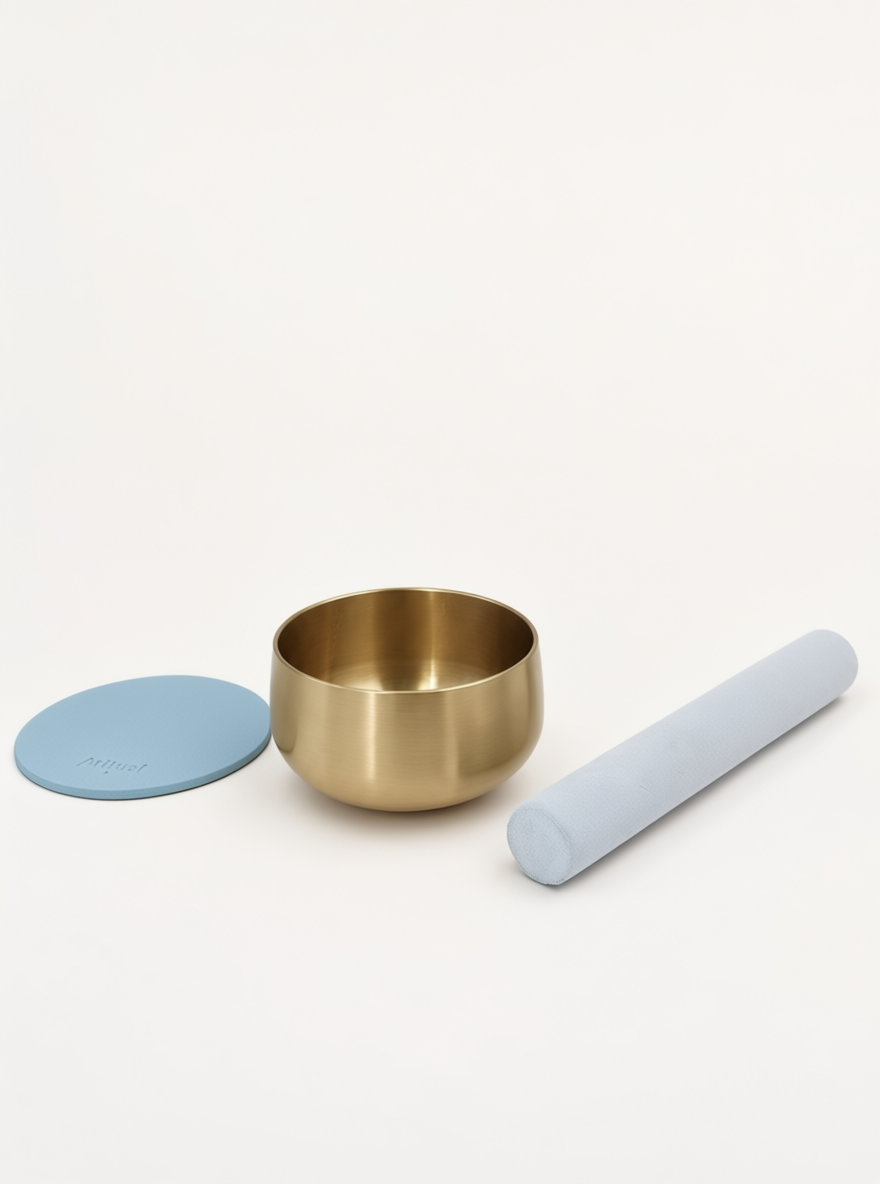 Singing Bowl Set laid out — brass bowl, suede mallet and powder blue leather pad