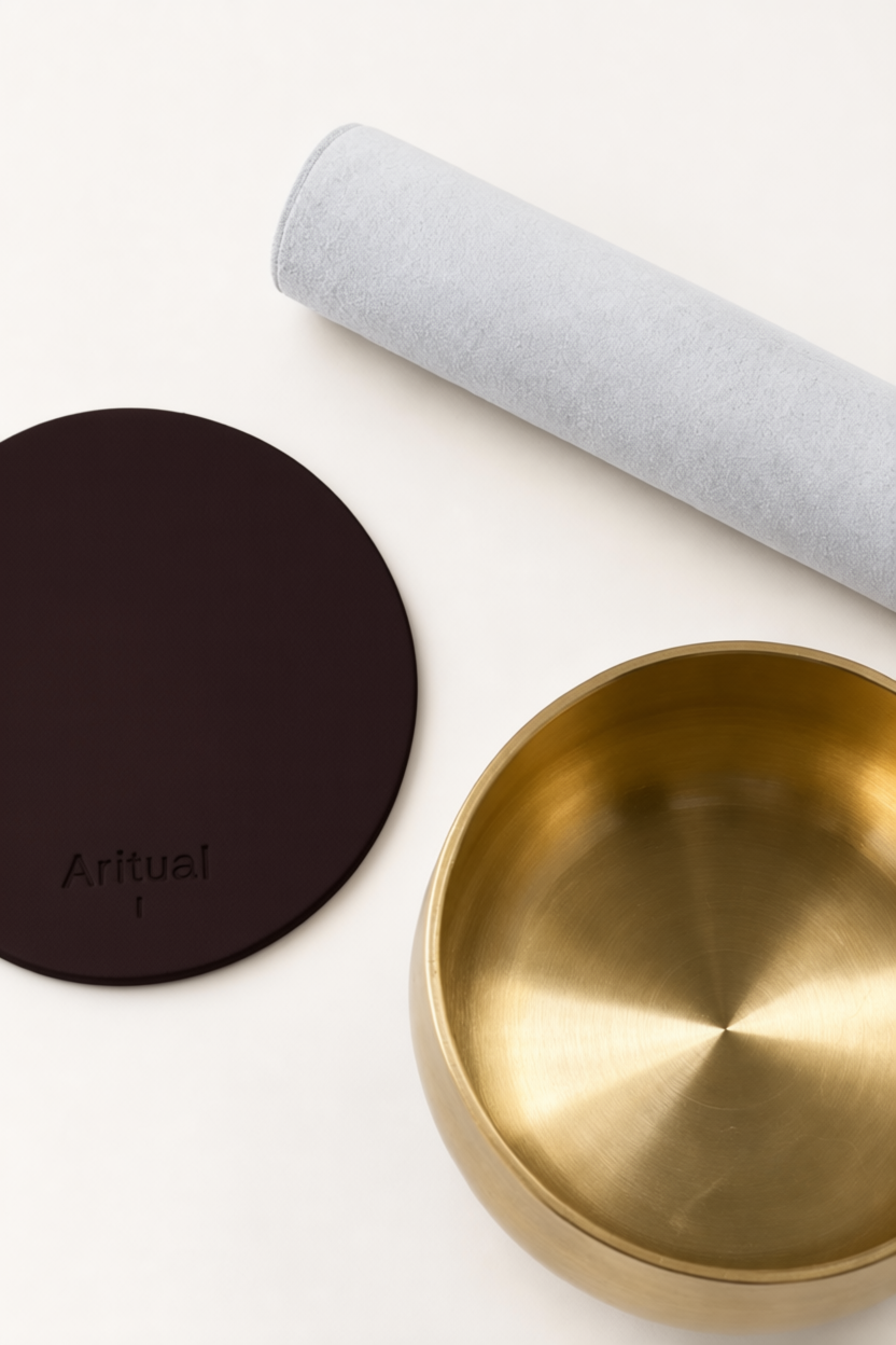 Overhead view of the brass bowl, suede mallet and deep brown pad