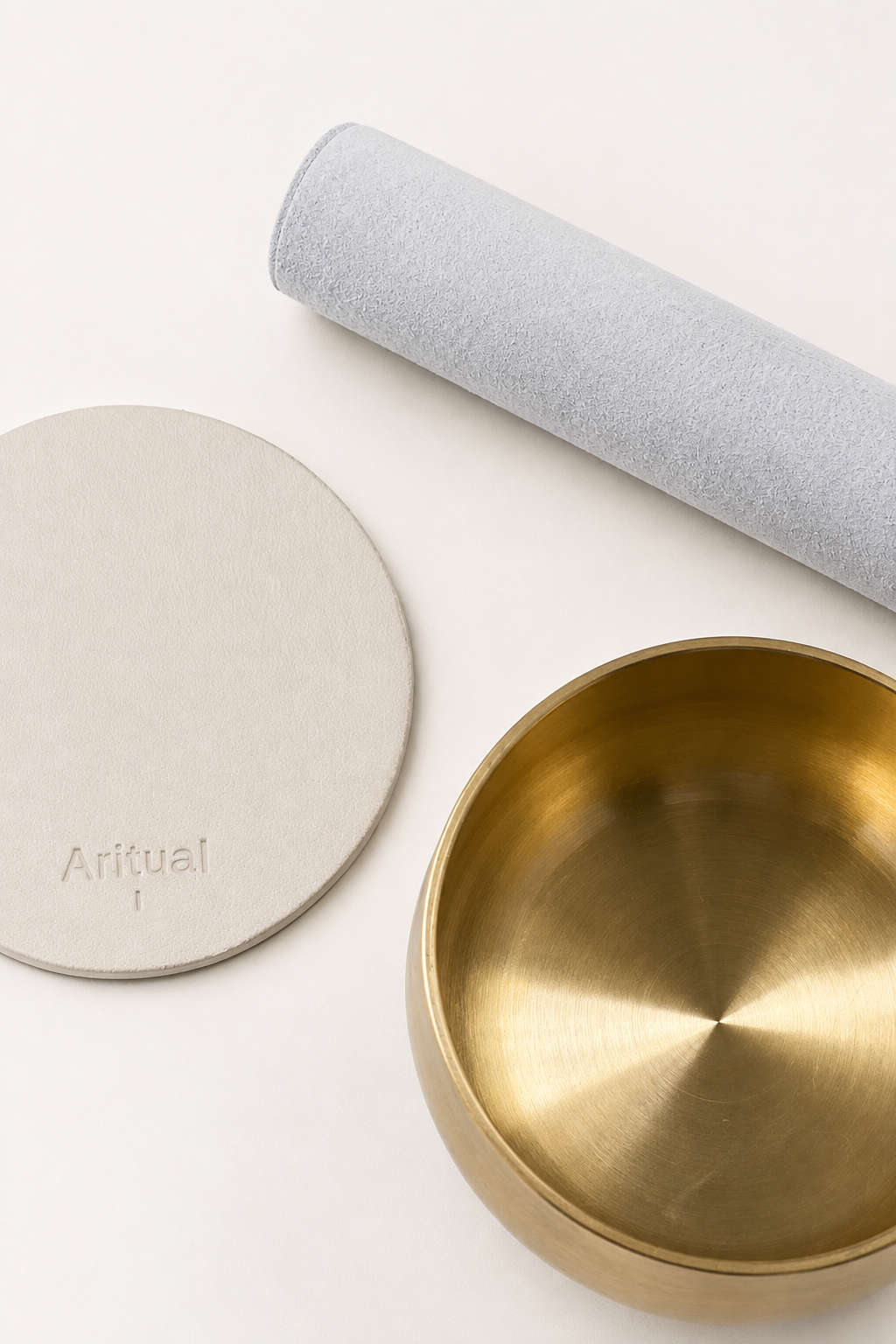 Overhead view of the brass bowl, suede mallet and ivory pad