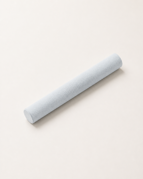 Aritual mallet lying at an angle, showing its suede-wrapped surface